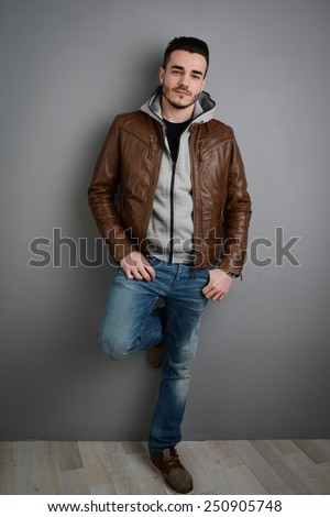 handsome young trendy man in a brown leather jacket
