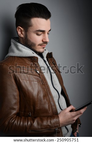handsome young trendy man in a brown leather jacket