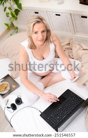 beautiful forty years old pregnant woman relaxed at home buying on internet
