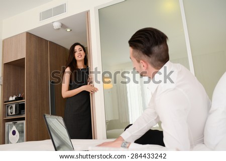 young business couple man and woman in hotel room