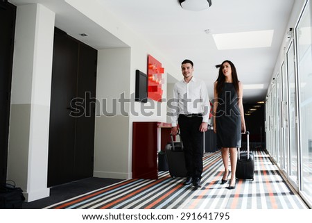 two young business person man and woman walking in a public space corridor