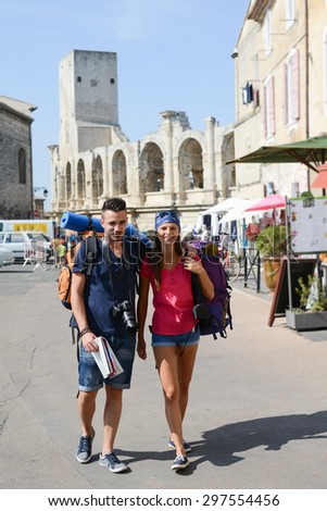 cheerful young couple backpacker traveling and sightseeing in europe during summer