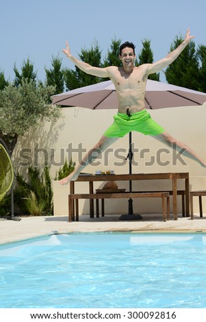 handsome young man jumping in a swimming pool