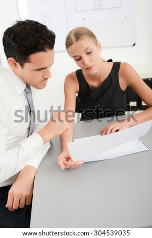 two young business people in meeting office looking at data documents