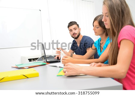portrait of a handsome young man student in a high school university classroom
