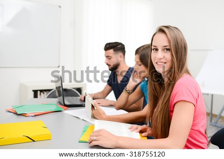 portrait of beautiful young girl student in high school university classroom