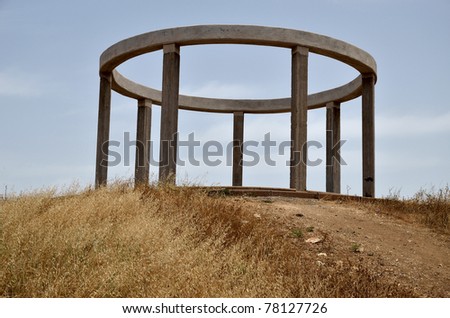 concrete pergola on a hill in the form of a ring on the columns