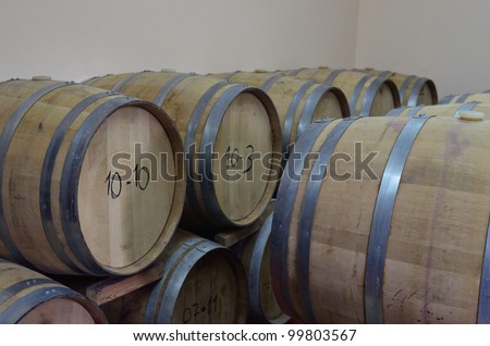 stacked oak barrels of wine in the basement