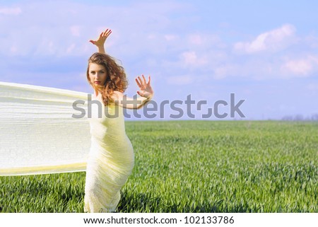 Cute flexible young woman wrapped in yellow cloth