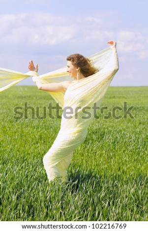Expressive beautiful young woman wrapped in yellow cloth