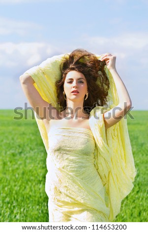 Portrait of a attractive young woman wrapped in yellow cloth