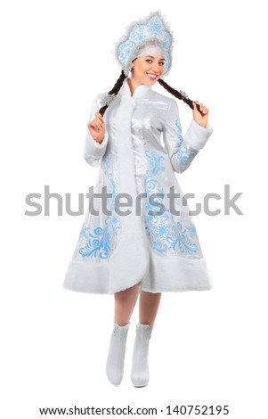 Young joyful lady dancing in winter costume. Isolated on white
