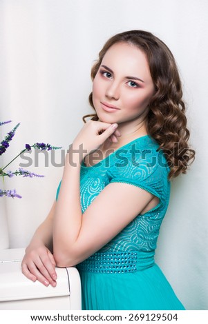 Portrait of pretty woman in turquoise dress