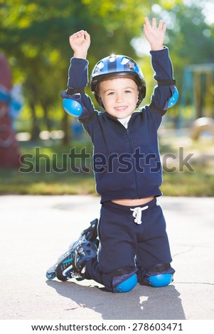 Playful little boy posing on the knee pads