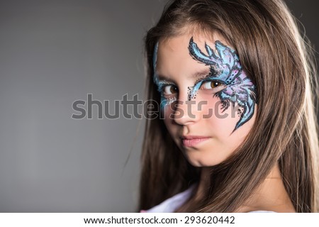 Nice girl posing with the pattern painted on her face