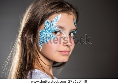 Portrait of a nice girl with the pattern painted on her face