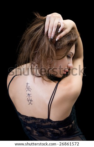 stock photo Tattoo on a back of the young woman