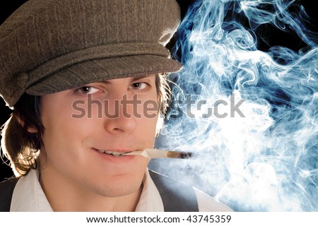 Portrait of smoking man with sly smile. Isolated on black