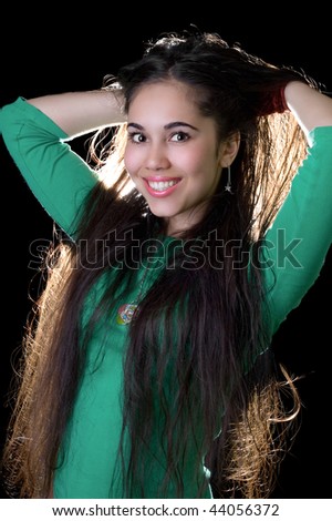 Young woman unbinding her long hair with a crazy look