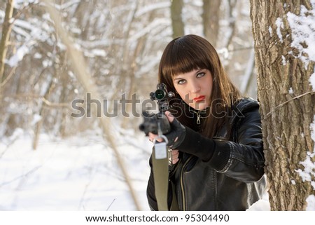 Portrait of sexy young woman with a sniper rifle