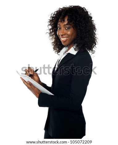 Attractive corporate lady preparing annual reports. Facing camera