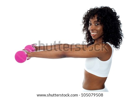 Fitness freak exercising with dumbbells. African slim lady