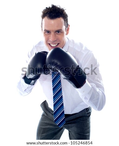 Business executive wearing boxing gloves. Ready to fight