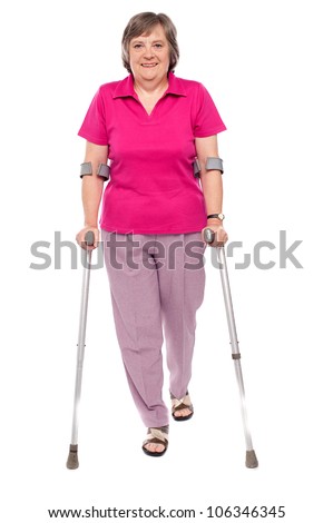 Full length portrait of an injured senior woman isolated over white background