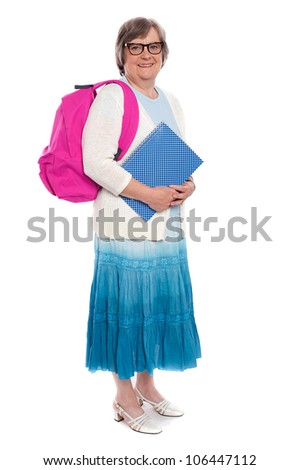 Its school time again. Full length portrait of an aged woman carrying school bag