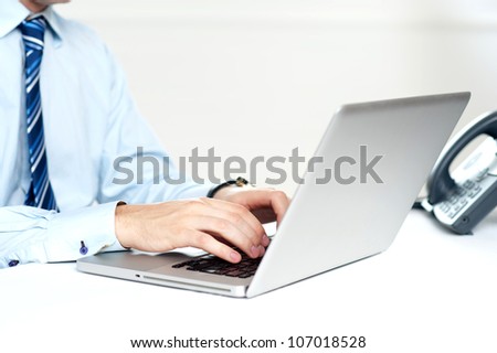 Closeup shot of man working on a laptop isolated over white background