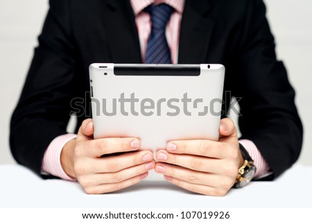 Businessman\'s hands holding portable device with touch screen technology