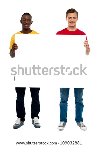 Trendy young guys presenting blank banner ad isolated over white background