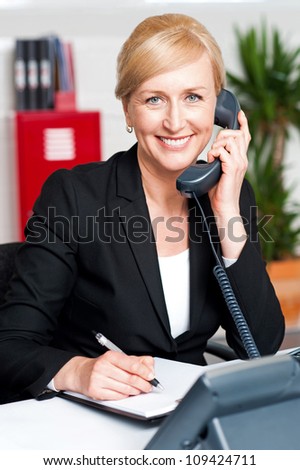 Corporate lady communicating on phone and confirming appointment