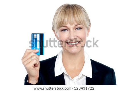 Joyous female employee showing her new credit card to the camera.