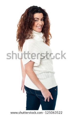 Gorgeous female turning back and smiling at you, white background.