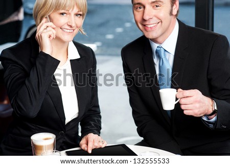 Business colleagues enjoying coffee and discussing business.