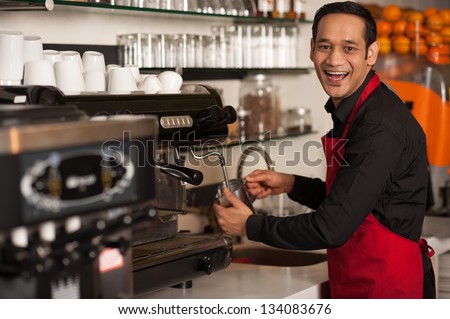 Cheerful male staff preparing customers order.