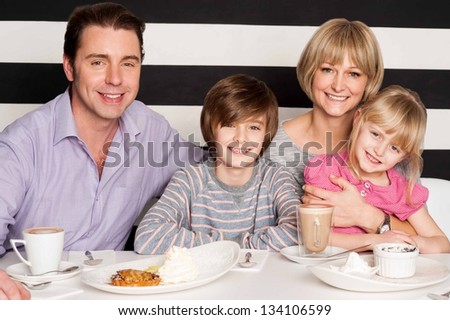 Family having rich breakfast in restaurant.