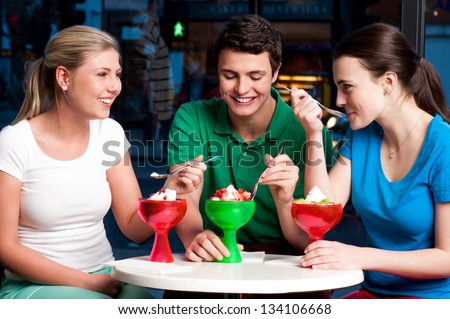 Three friends enjoying day out in a restaurant.