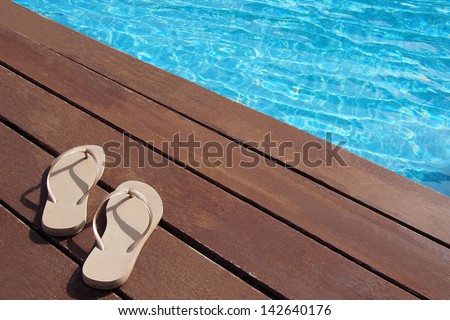 Men\'s flip-flops by the swimming pool