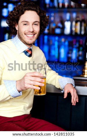 Handsome young guy holding beer glass