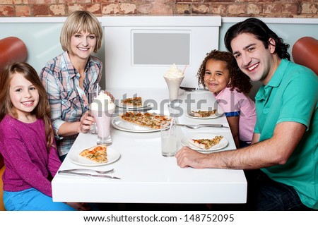 Family of four having great time in a restaurant
