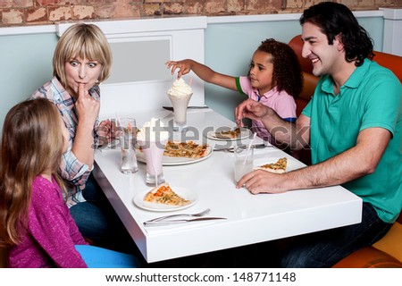 Family of four having great time in a restaurant