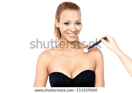 Beautiful young female model getting makeup done