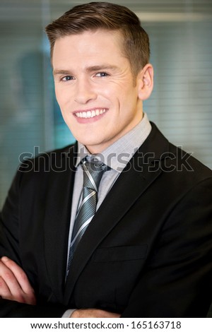 Corporate guy posing with arms crossed