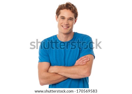Confident young guy posing with arms crossed