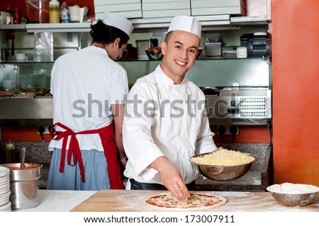 Male chefs working in kitchen, back-office shot