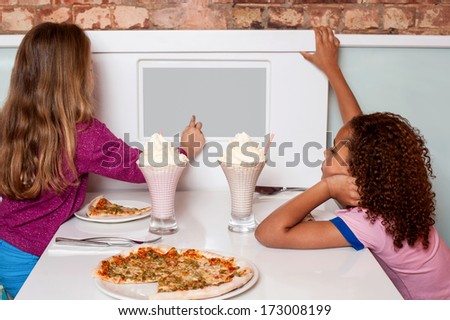 Little girls placing an order through digital menu