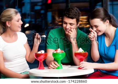 Three friends enjoying day out in a restaurant.