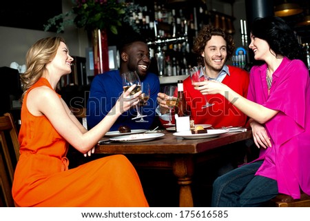 Friends At The Bar Raising Their Glasses For A Toast